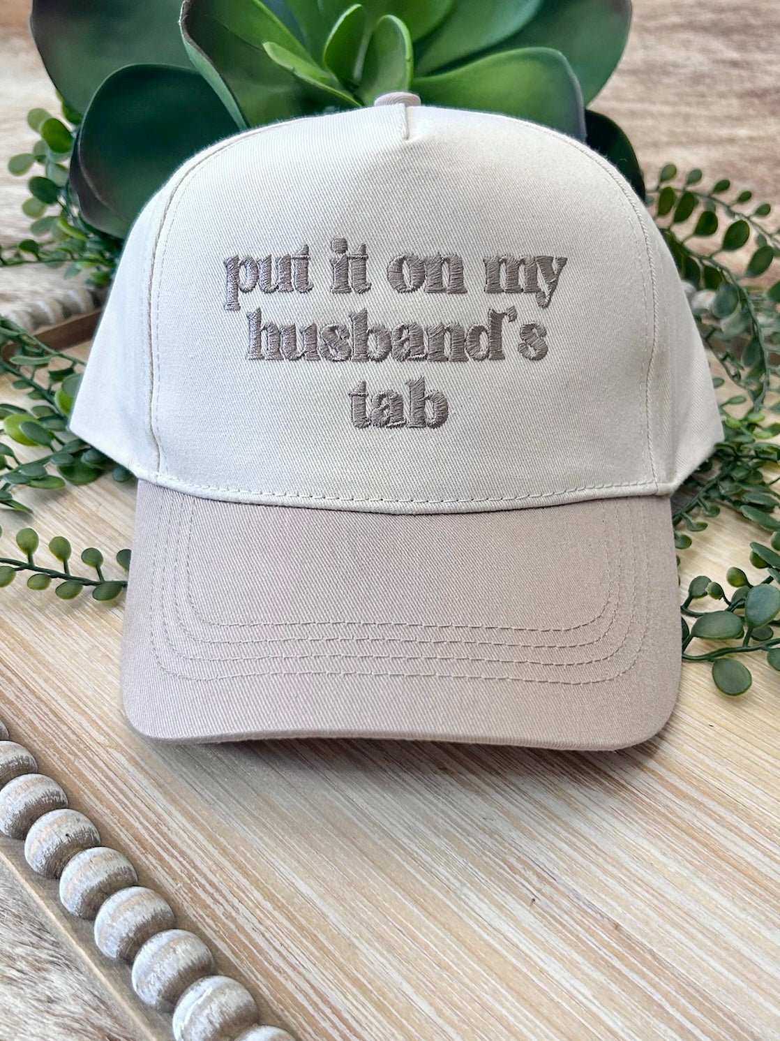 Put It On My Husband's Tab Beige Embroidered Trucker Hat
