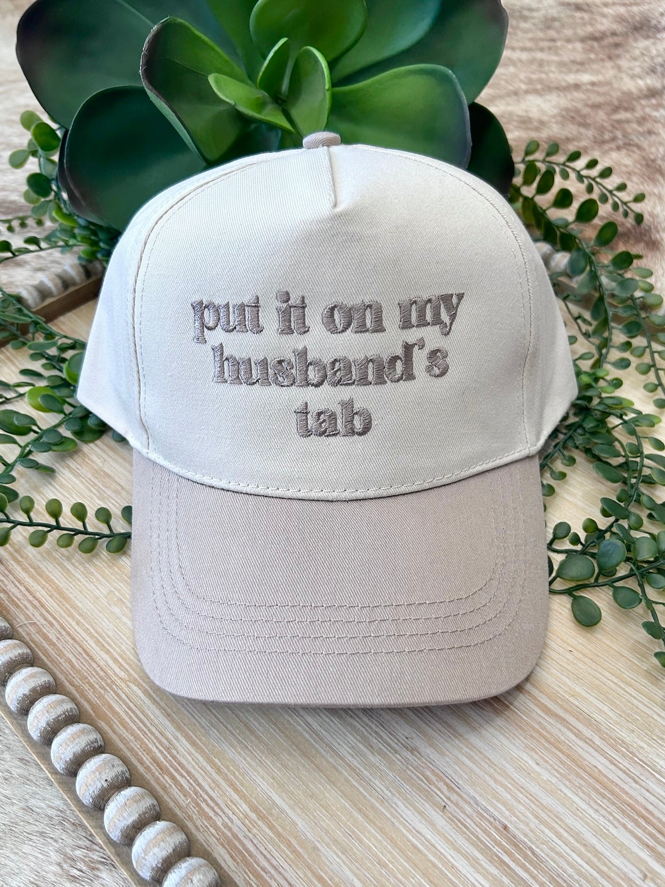 Put It On My Husband's Tab Beige Embroidered Trucker Hat